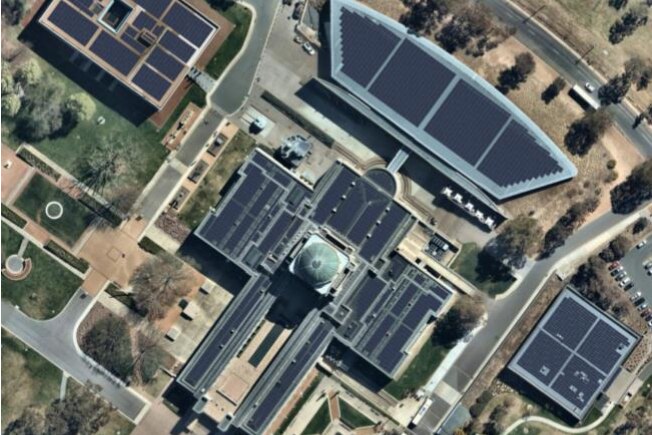 An aerial photo of the Australian War Memorial with solar panels added to every available roof space