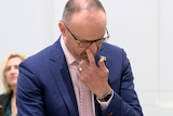 Andrew Barr wipes a tear as he introduces a piece of legislation in the ACT Legislative Assembly chamber.
