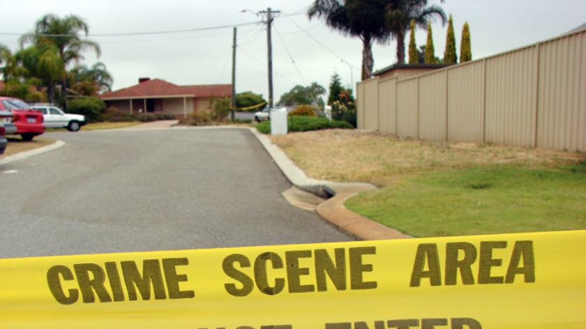 Police crime scene tape across road