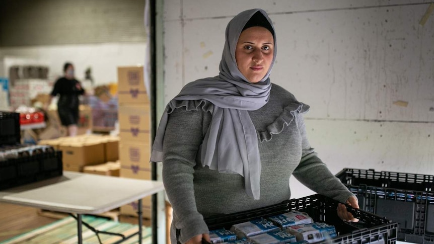 A woman packs eggs