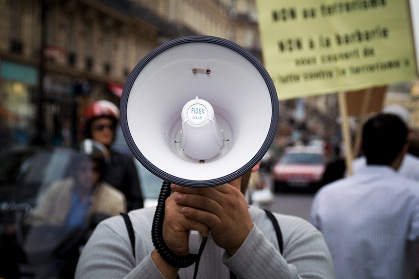 A close photo of a megaphone being used at a protest