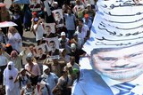 Mohamed Morsi protesters carry posters in street