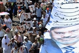 Supporters of the deposed president Mohamed Morsi carry a giant poster bearing his portrait during a 2013 demonstration.