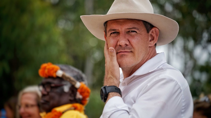 NT Chief Minister Michael Gunner wears a hat and looks at the camera