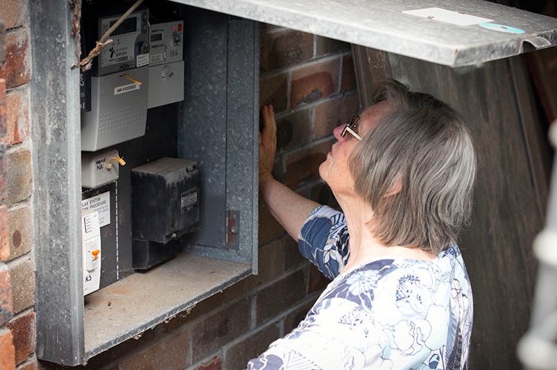 Sydney retiree Merinda Air looking inside her home's energy box