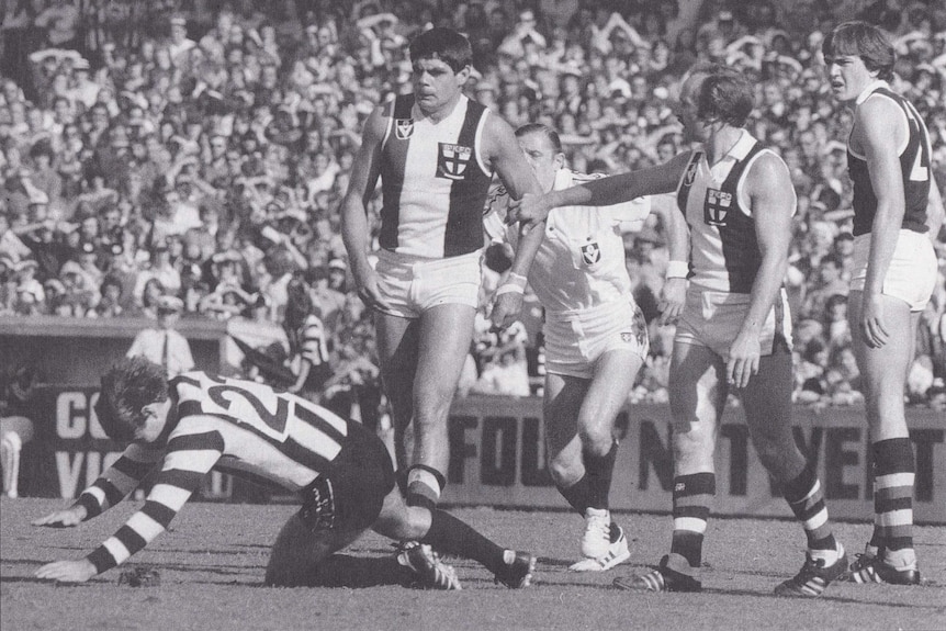 Ray Shaw falls to the ground during a football match.