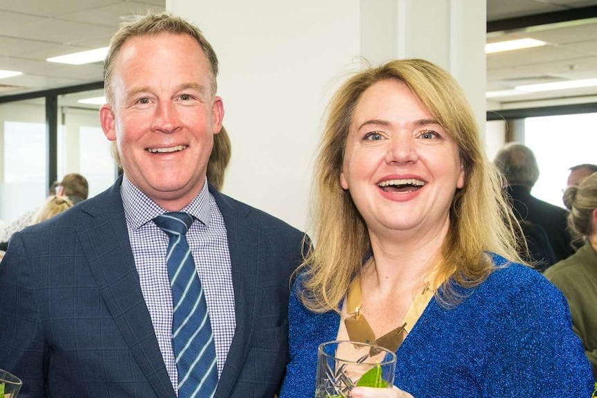 Will Hodgman and Madeleine Ogilvie with another man at an office opening function.