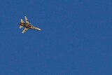 A war jet flies above Syria
