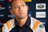 Christian Lealiifano at a press conference looks off in the distance, as if he is reflecting.