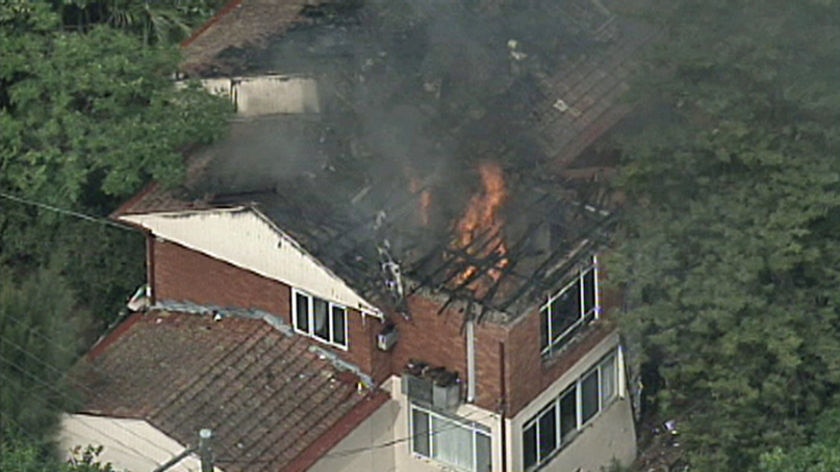 TV still of the roof of a house on fire in Sydney's north in Castlecrag after lightning struck it