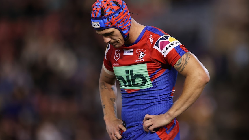 A rugby league player looks despondent 