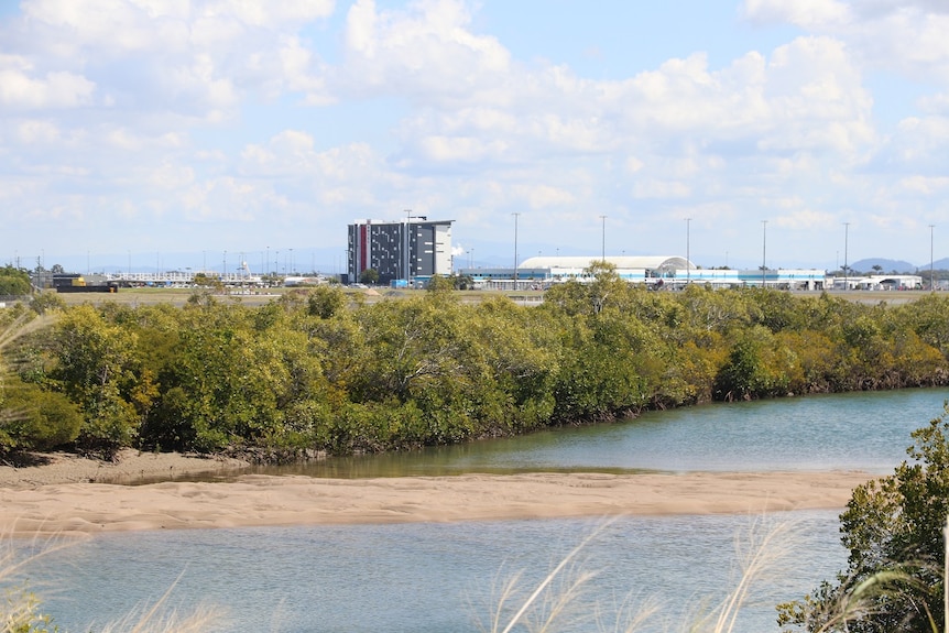 A small waterway with some buildings in the background