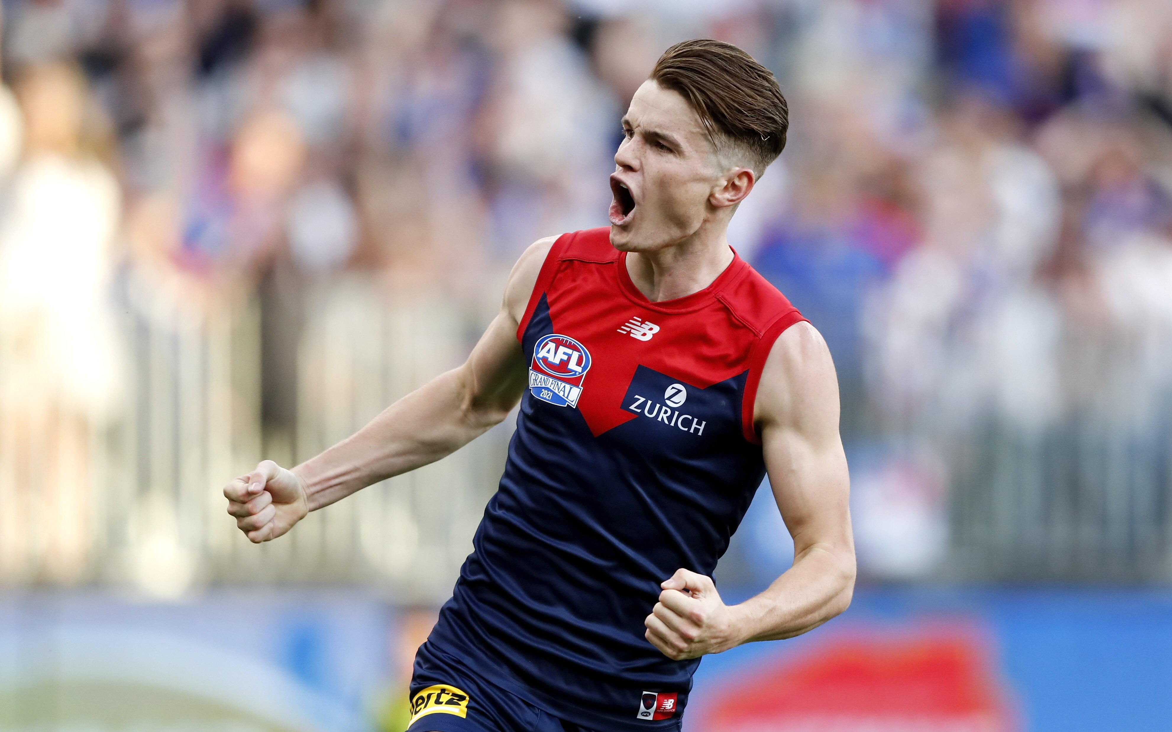 Melbourne Demons' Bayley Fritsch pumps both fists after a goal in the AFL grand final.