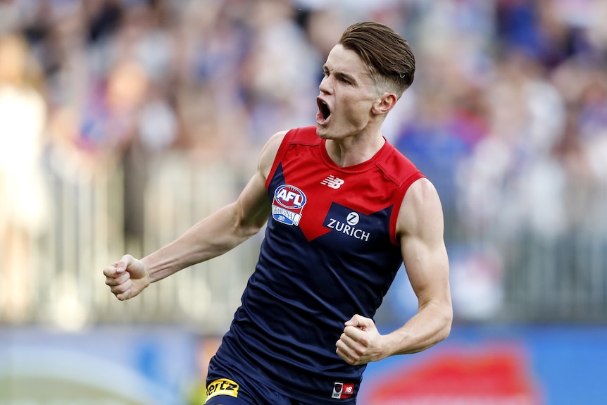 Melbourne Demons' Bayley Fritsch pumps both fists after a goal in the AFL grand final.
