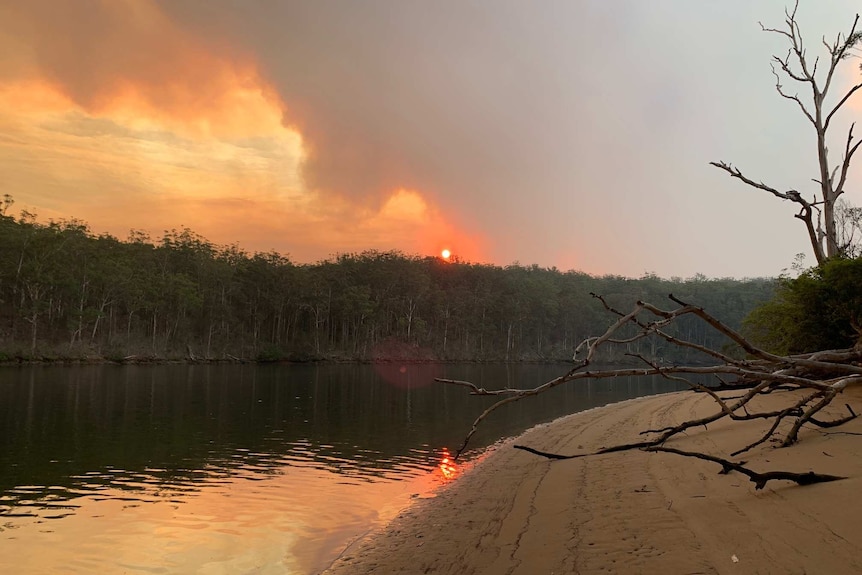 A quiet river with a hint of bushfires in the distance