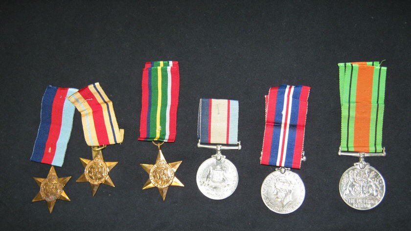 The name J.P. McGuire is inscribed on the back of the medals.