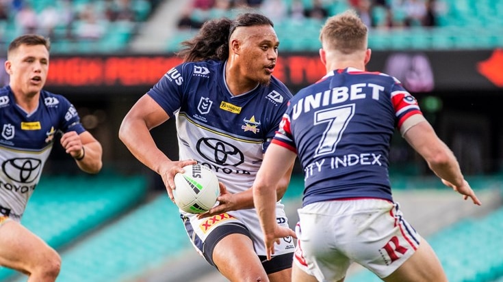 A North Queensland Cowboys player holding a football while running