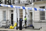 A police officer guards a property in Pimlico