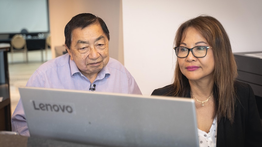 Harry Hunt and Irma Young looking at a laptop screen.