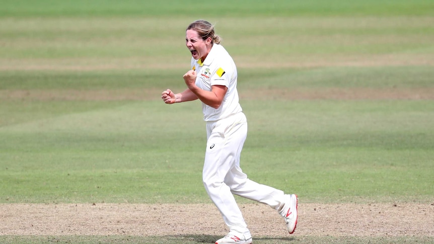 Australian bowler Sophie Molineux pumps her fist in the middle of the pitch.