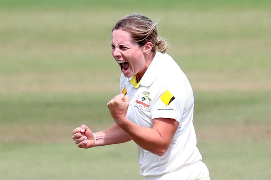 Australian bowler Sophie Molineux pumps her fist in the middle of the pitch.