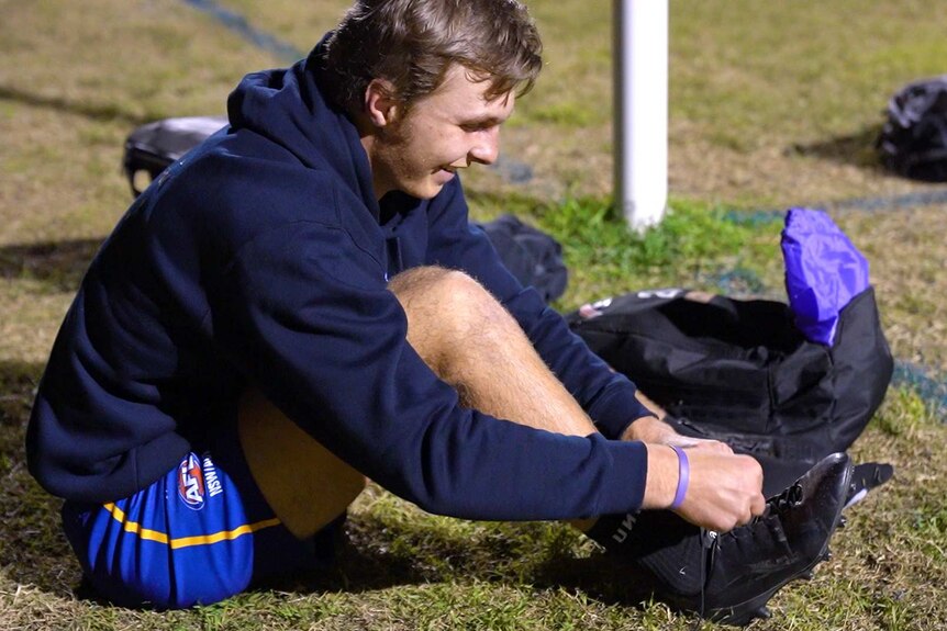 AFL prospect Morgan Dunn tying up his laces.