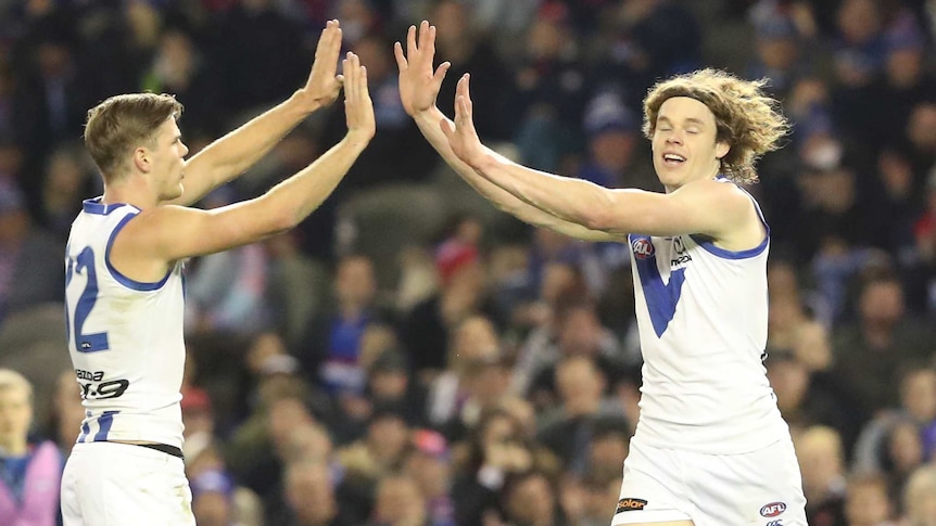 Ben Brown (on R) after scoring a goal for North Melbourne against Western Bulldogs.