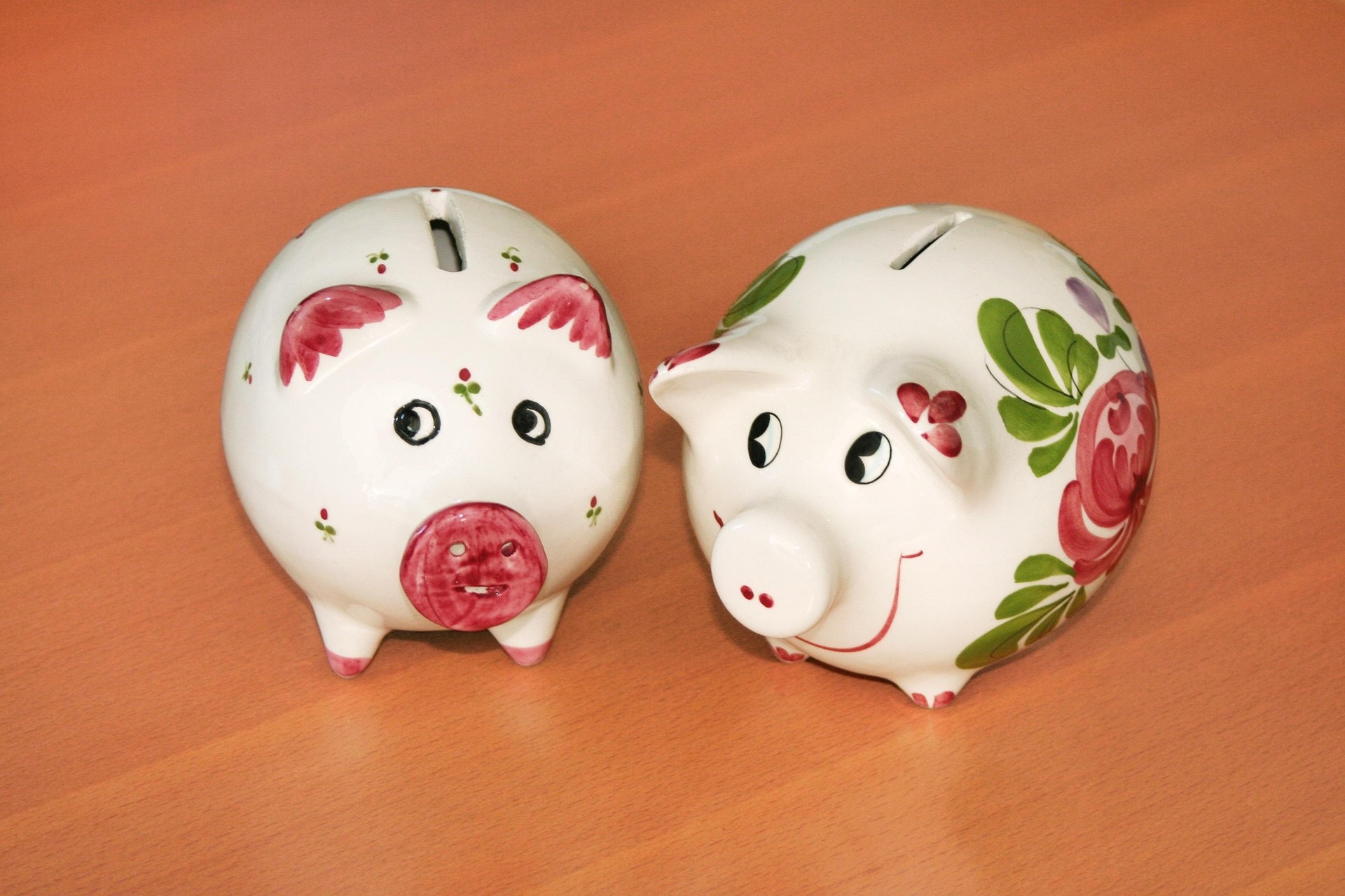 Two piggy banks on a table