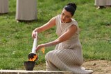 Greek actress Maria Nafpliotou lit the flame at the Ancient Stadium.