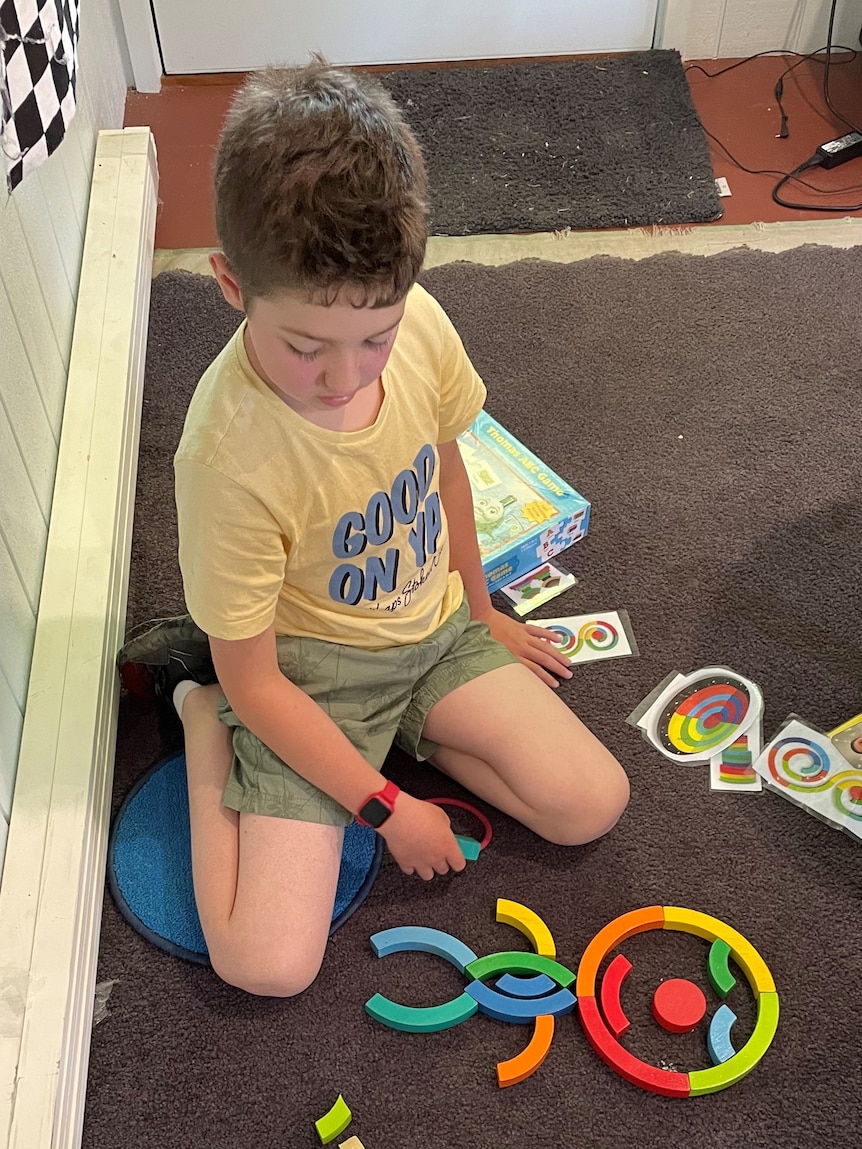 A boy plays with toys