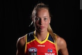 Jasmine Simmons poses for a photograph in the Adelaide Crows guernsey. 