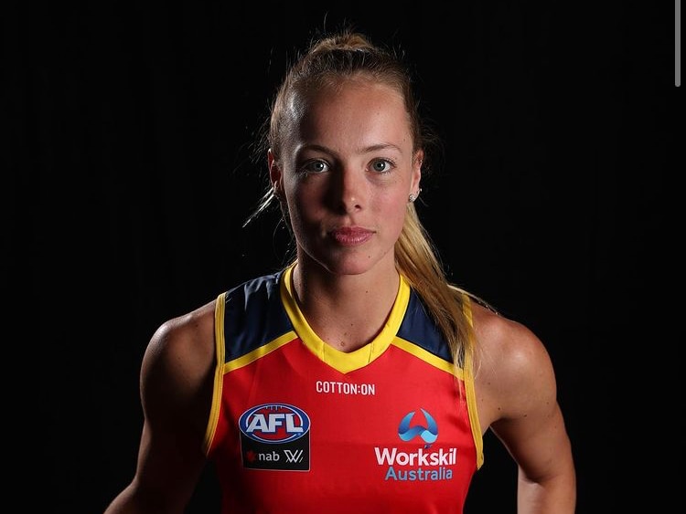 Jasmine Simmons poses for a photograph in the Adelaide Crows guernsey. 