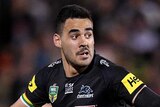 Penrith Panthers player Tyrone May is caught by Warriors defender Peta Hiku during an NRL game.
