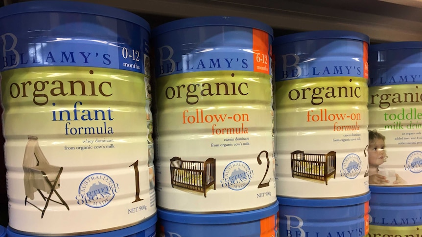 Tins of infant formula sitting on the shelf