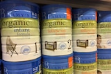 Tins of infant formula sitting on the shelf