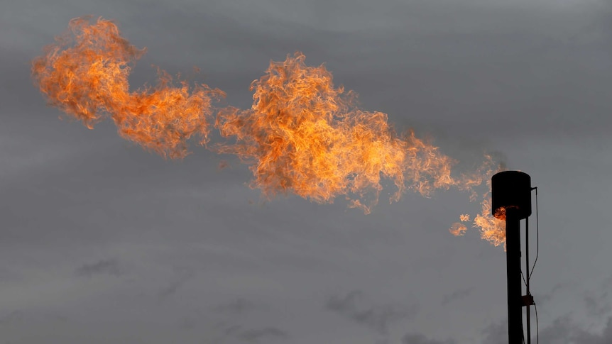 Fire burns with clouds in the background