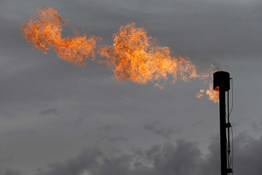 Fire burns with clouds in the background