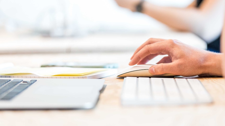 Healthcare worker uses laptop.