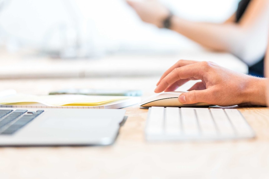 Healthcare worker uses laptop.