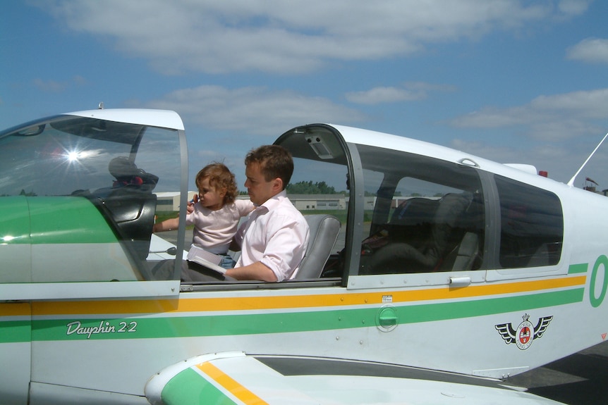 Baby Zara in 2004 sits on her father's lap in a small plane