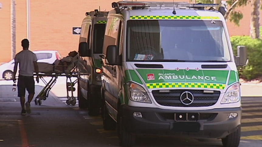 Two ambulances line up outside hospital entrance