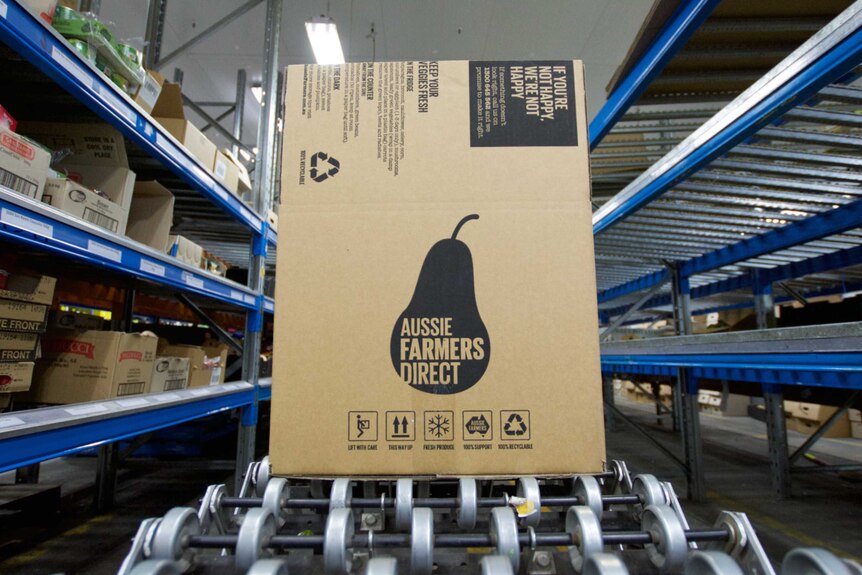 A large box for Aussie Farmers Direct sits between shelves.