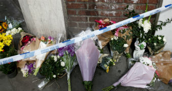 Flowers site behind police tape at a London Bridge attack memorial.