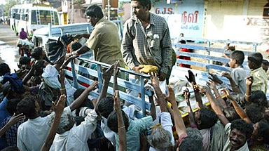 Rescue workers distribute food and clothes in India.
