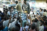 Indian rescue workers distribute food and clothes to people affected by the tsunami.