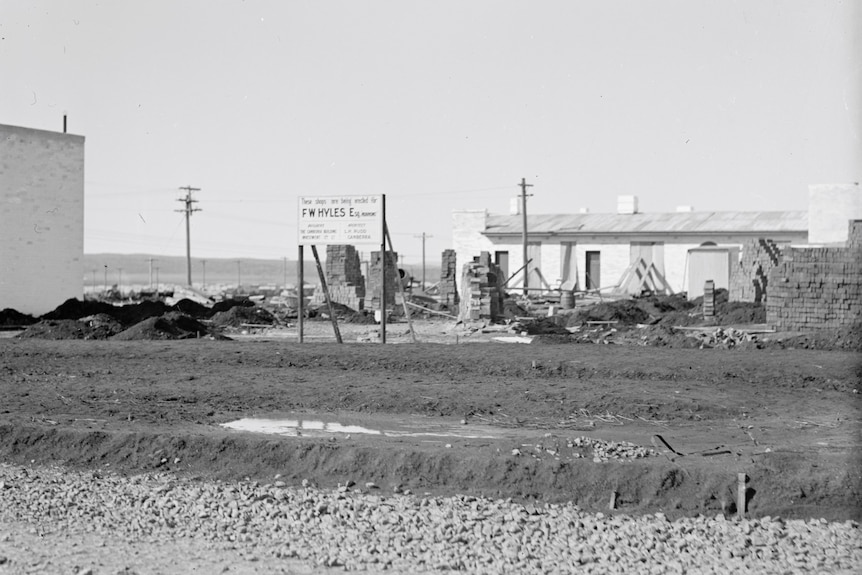 old black and white photo showing construction on the site of kingston shops