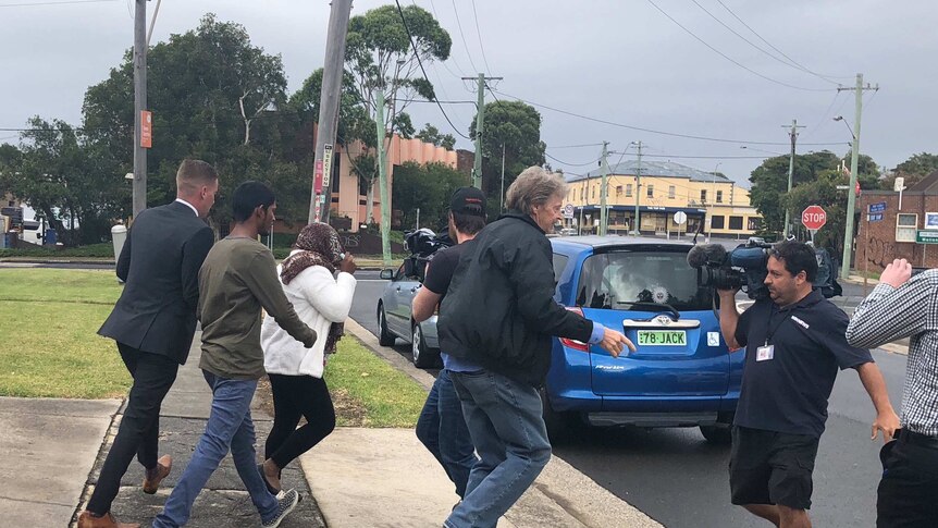 48-year-old formed aged care worker, Shakuntala Mudliar, leaves Port Kembla Local Court with her supporters