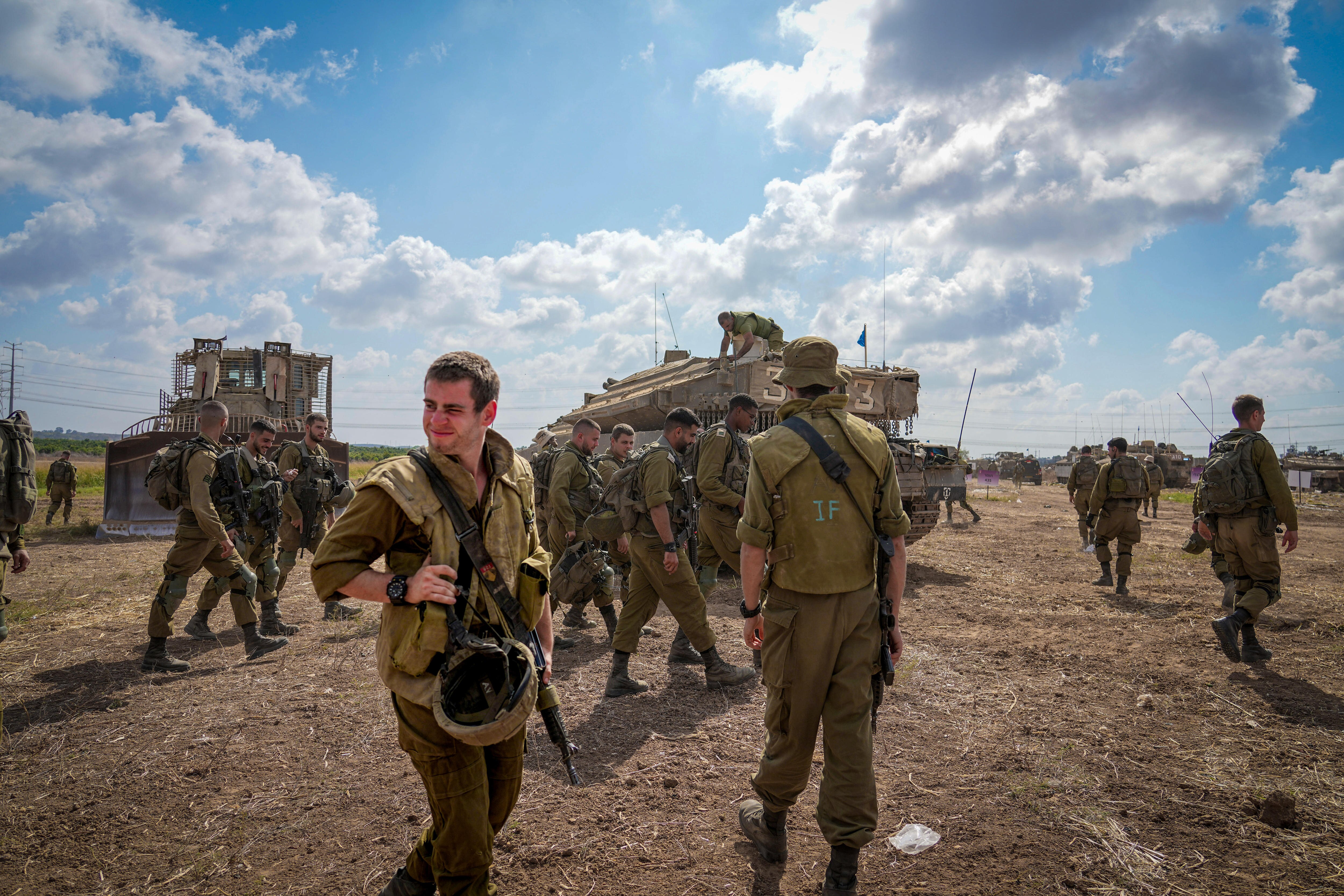 Soldiers milling about a tank