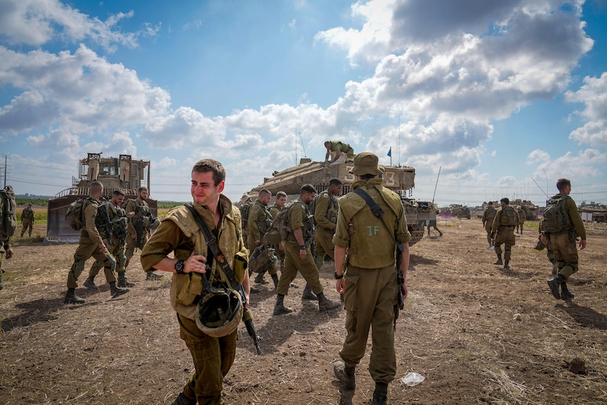 Soldiers milling about a tank