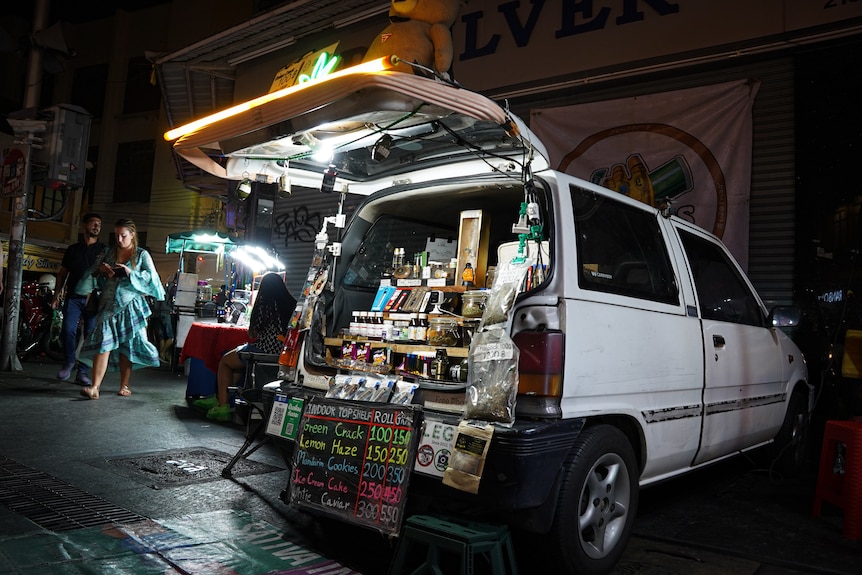 An open white van shows the boot filled with various cannabis products for sale